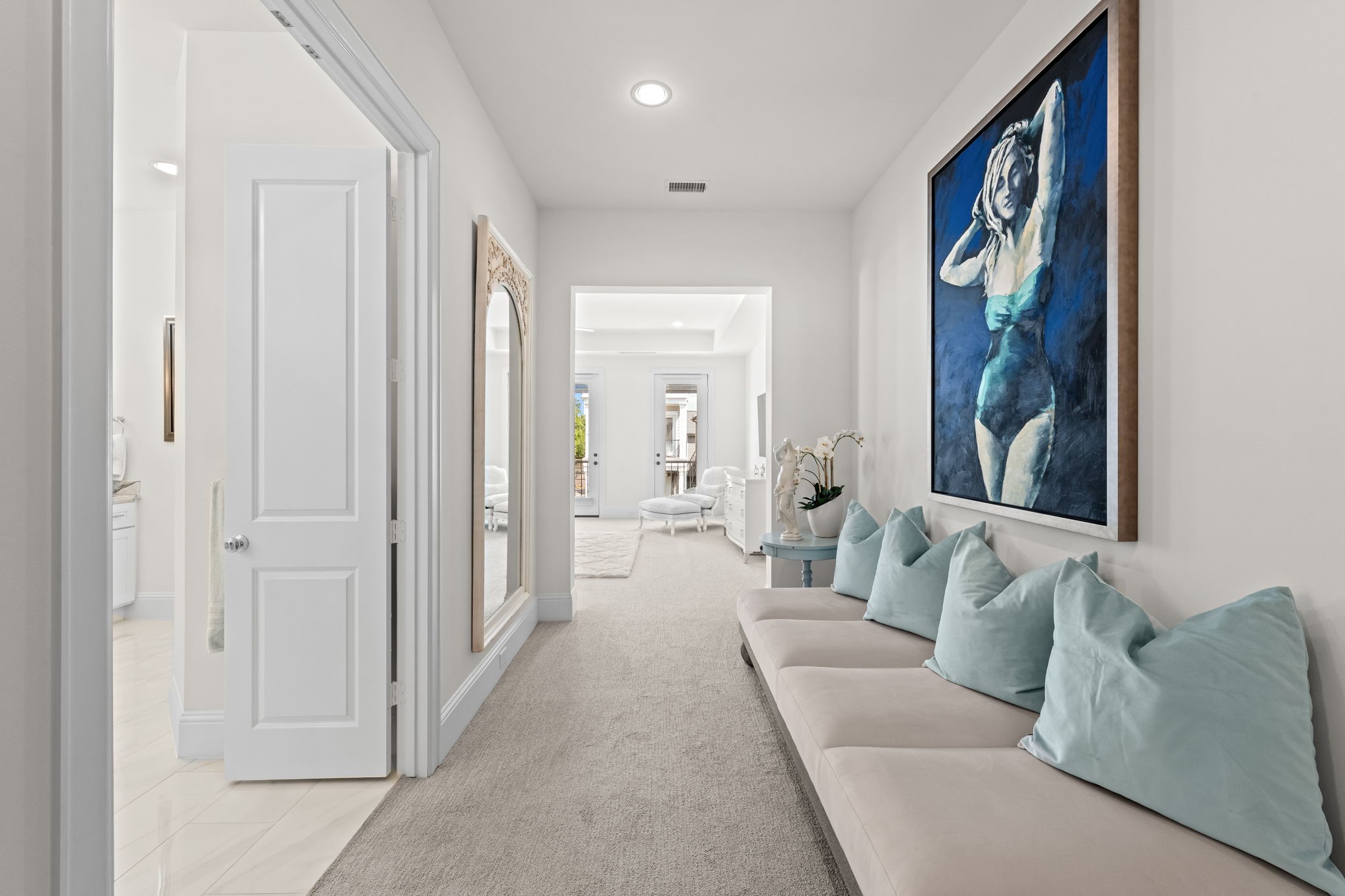 110 East 26th Street, Unit B Houston, TX 77008 - Photo 22 of 43 Behind its own set of doors, the primary suite exists as a completely separate sanctuary from the rest of the home. This expansive retreat features a versatile sitting area that acts as a peaceful buffer, leading into the spacious bedroom and a luxurious bath. It’s a masterfully designed space that prioritizes seclusion, offering pure retreat vibes in a wing of its own.