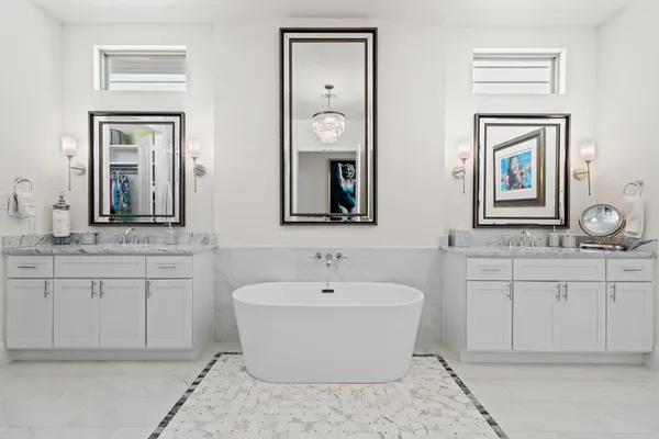 a bathroom with a granite countertop sink double and mirror