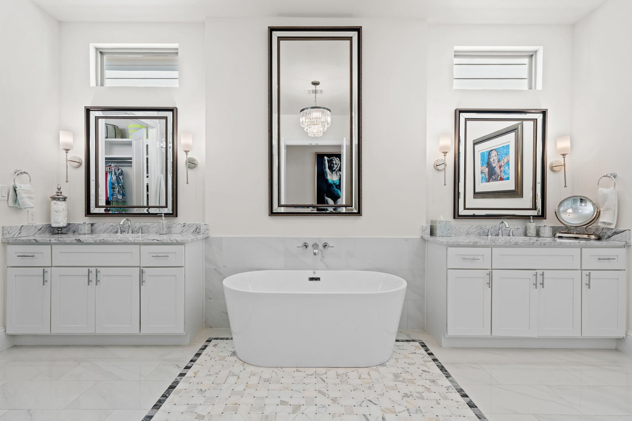 110 East 26th Street, Unit B Houston, TX 77008 - Photo 26 of 43 This stunning primary bath feels like a high-end hotel—only better. It features a luxurious soaking tub for ultimate relaxation, complemented by separate vanities and marble flooring detailed with ornate tiling. Unique tray windows bring in soft light, making this an impactful yet serene space to unwind.