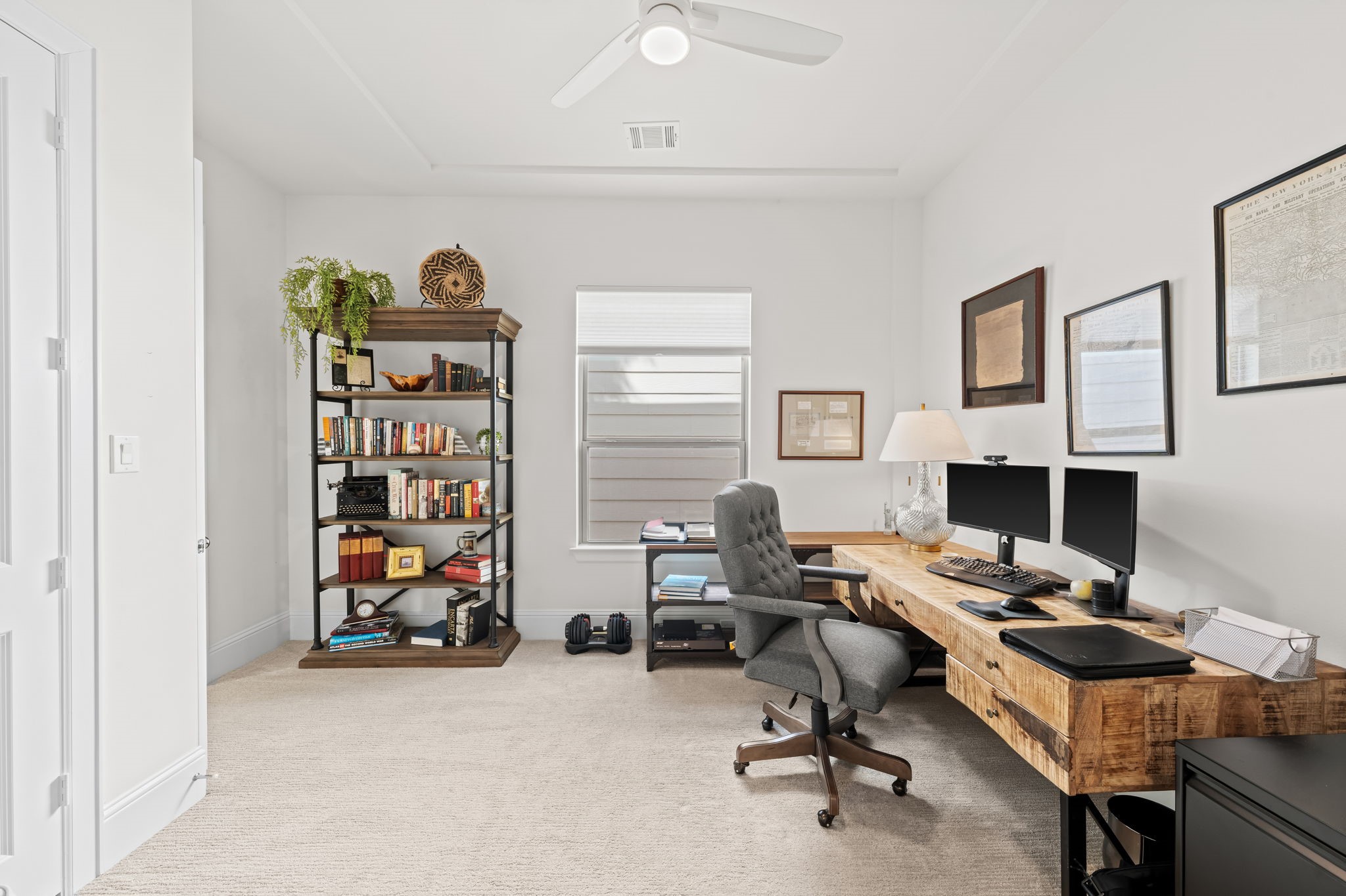 110 East 26th Street, Unit B Houston, TX 77008 - Photo 30 of 43 This additional view of the secondary bedroom—currently serving as a sophisticated home office—showcases its high ceilings and refined architectural details. A sleek, modern fan and ample natural light create a productive workspace, though its generous proportions make for an easy transition back to a bedroom. This space also offers direct access to a shared Jack and Jill bath, connecting it seamlessly to the third bedroom for a convenient and private layout.