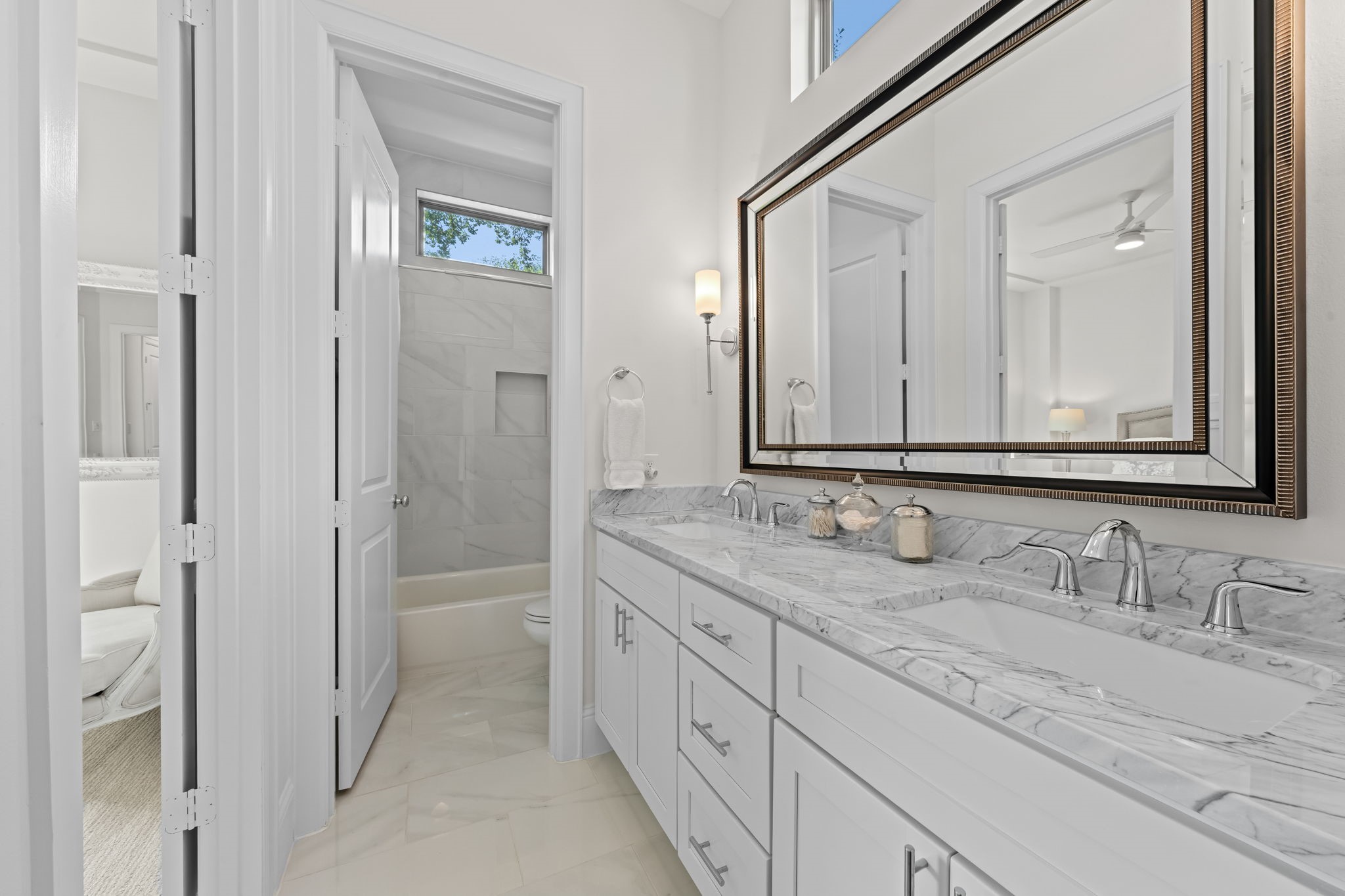 110 East 26th Street, Unit B Houston, TX 77008 - Photo 31 of 43 This beautiful bathroom is designed for both style and shared efficiency, featuring a clever layout that separates the vanity area from the water room. With double sinks, stunning countertops, and an abundance of cabinet storage, it provides a spacious and organized environment that perfectly serves the adjacent bedrooms.