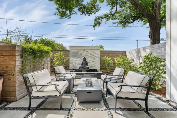 a view of a patio with table and chairs and potted plants
