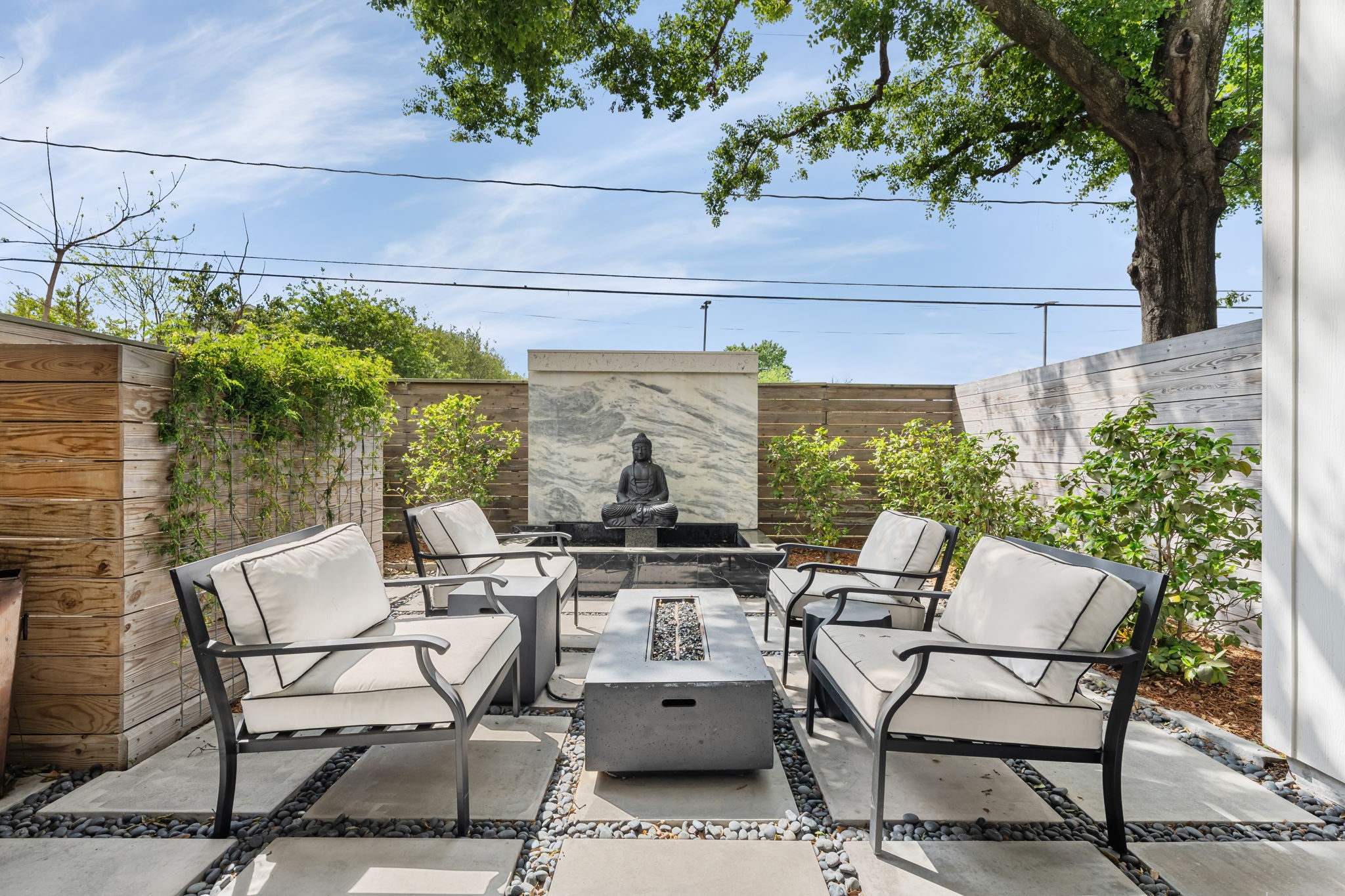 110 East 26th Street, Unit B Houston, TX 77008 - Photo 4 of 43 This serene backyard is the ultimate retreat, offering a rare sense of peace and complete privacy. The design balances beauty with effortless living, featuring mature landscaping that frames the space in greenery. High-quality pavers and decorative rock create a clean, functional environment that is as easy to maintain as it is to enjoy—perfect for quiet mornings or alfresco evenings in your own hidden sanctuary.