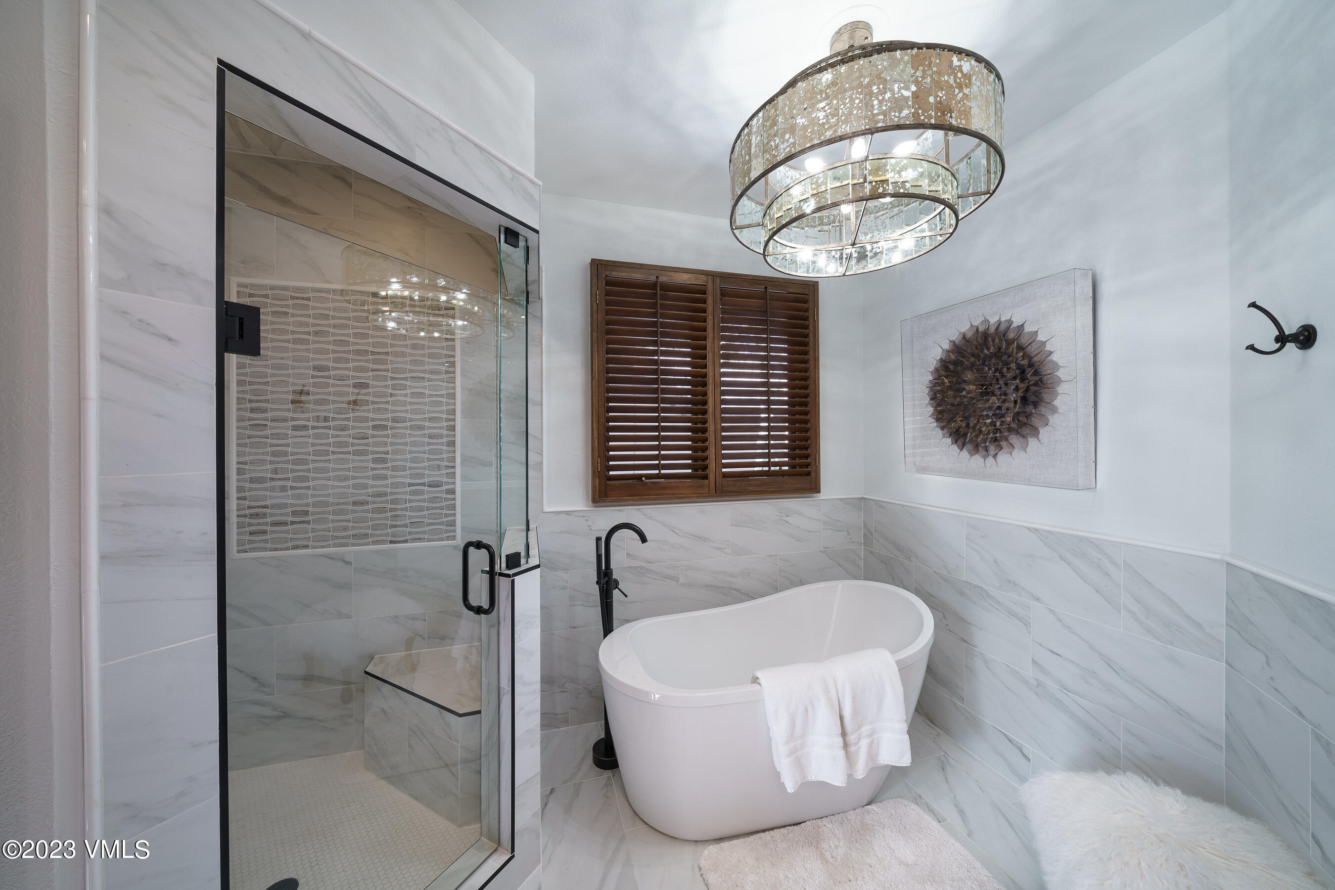 176 Windermere Circle Edwards, CO 81632 - Photo 21 of 42 a bathroom with a bathtub and a chandelier