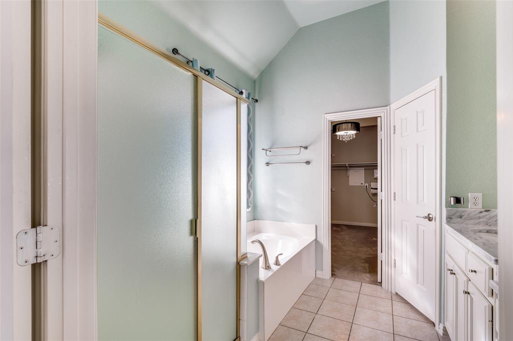 3912 Sovereign Drive Bedford, TX 76021 - Photo 18 of 34 Full bath with separate shower, a bath, tile patterned flooring, vanity, and lofted ceiling