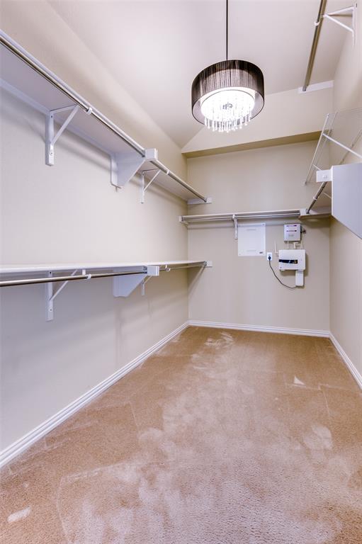 3912 Sovereign Drive Bedford, TX 76021 - Photo 19 of 34 Spacious closet featuring carpet floors and a chandelier