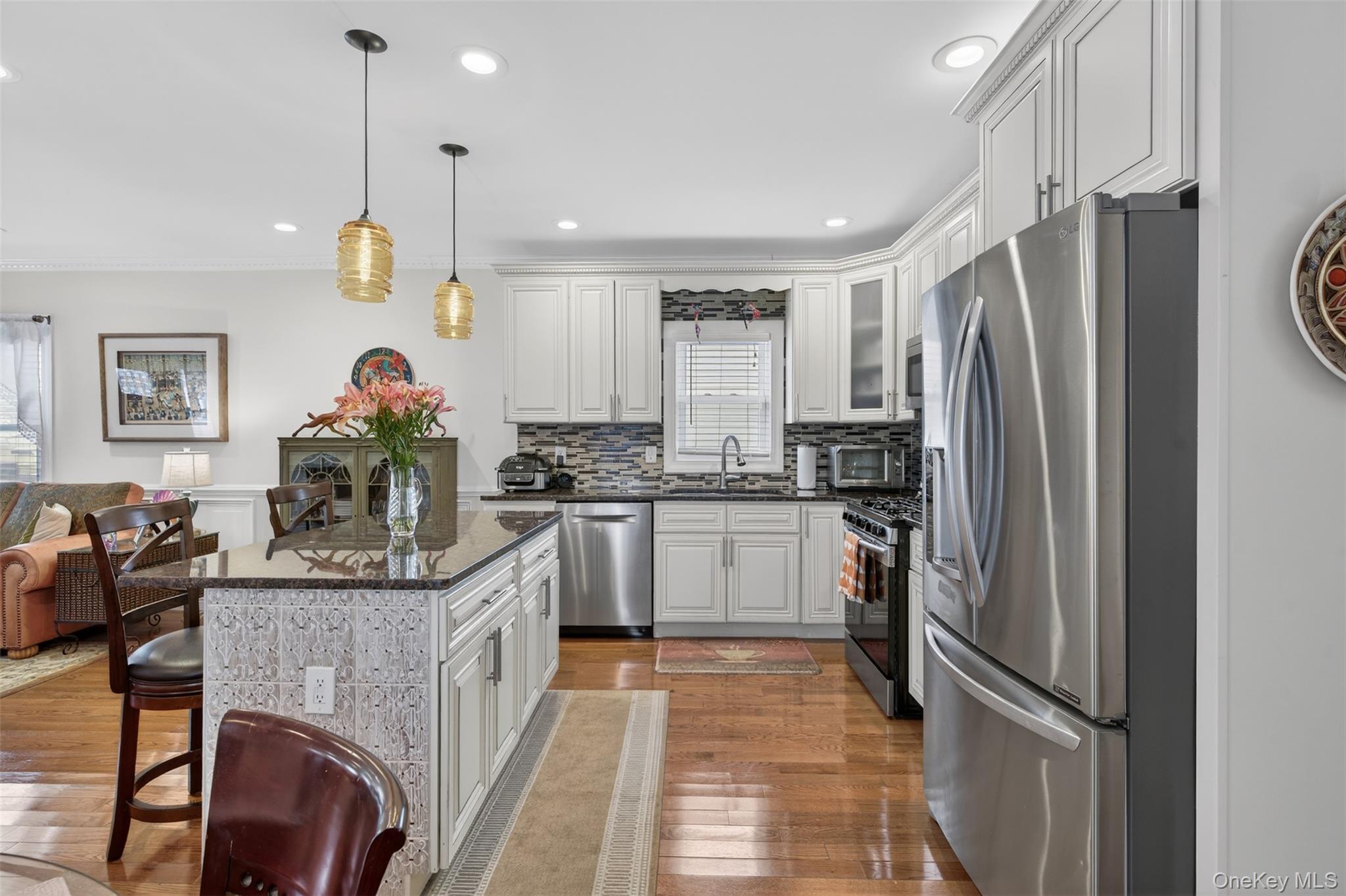 35 Kent Street Beacon, NY 12508 - Photo 14 of 40 The kitchen boasts maple cabinets, a spacious island, granite countertops, stainless steel appliances, and a sleek glass backsplash.