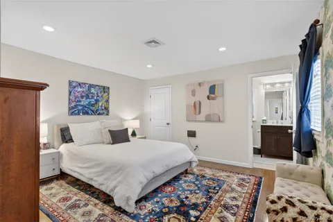 a bedroom with a large bed and a couch