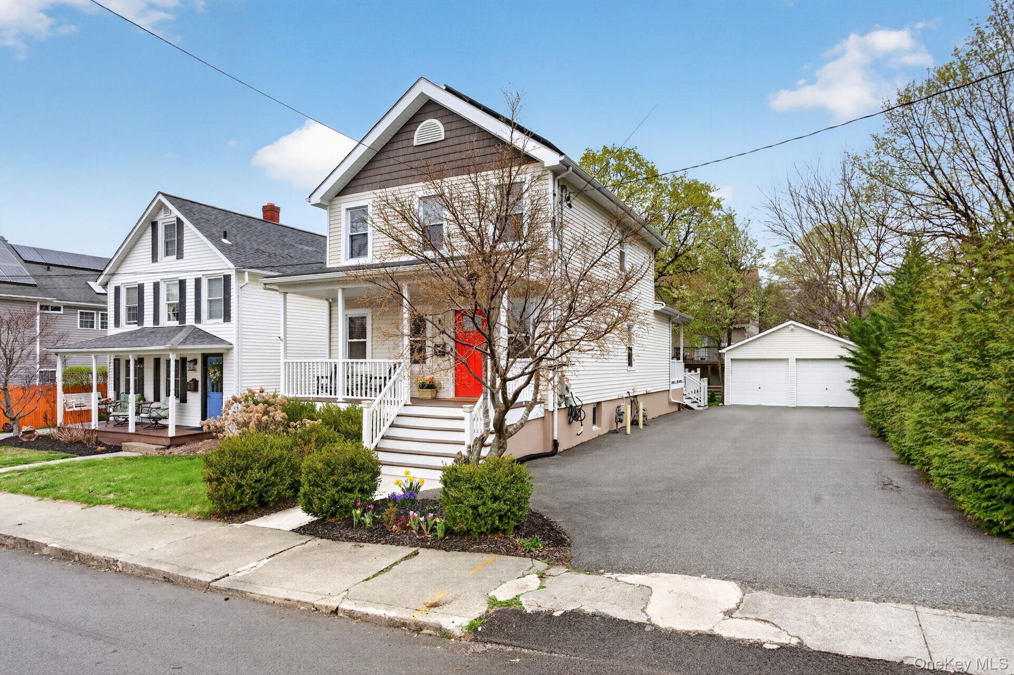 35 Kent Street Beacon, NY 12508 - Photo 3 of 42 a front view of a house with a yard and garage