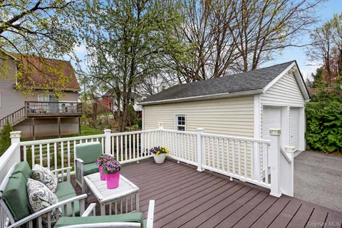 a view of a deck with furniture and wooden floor