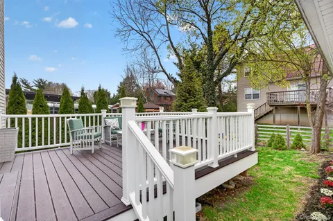 a view of a wooden deck and a yard with wooden fence