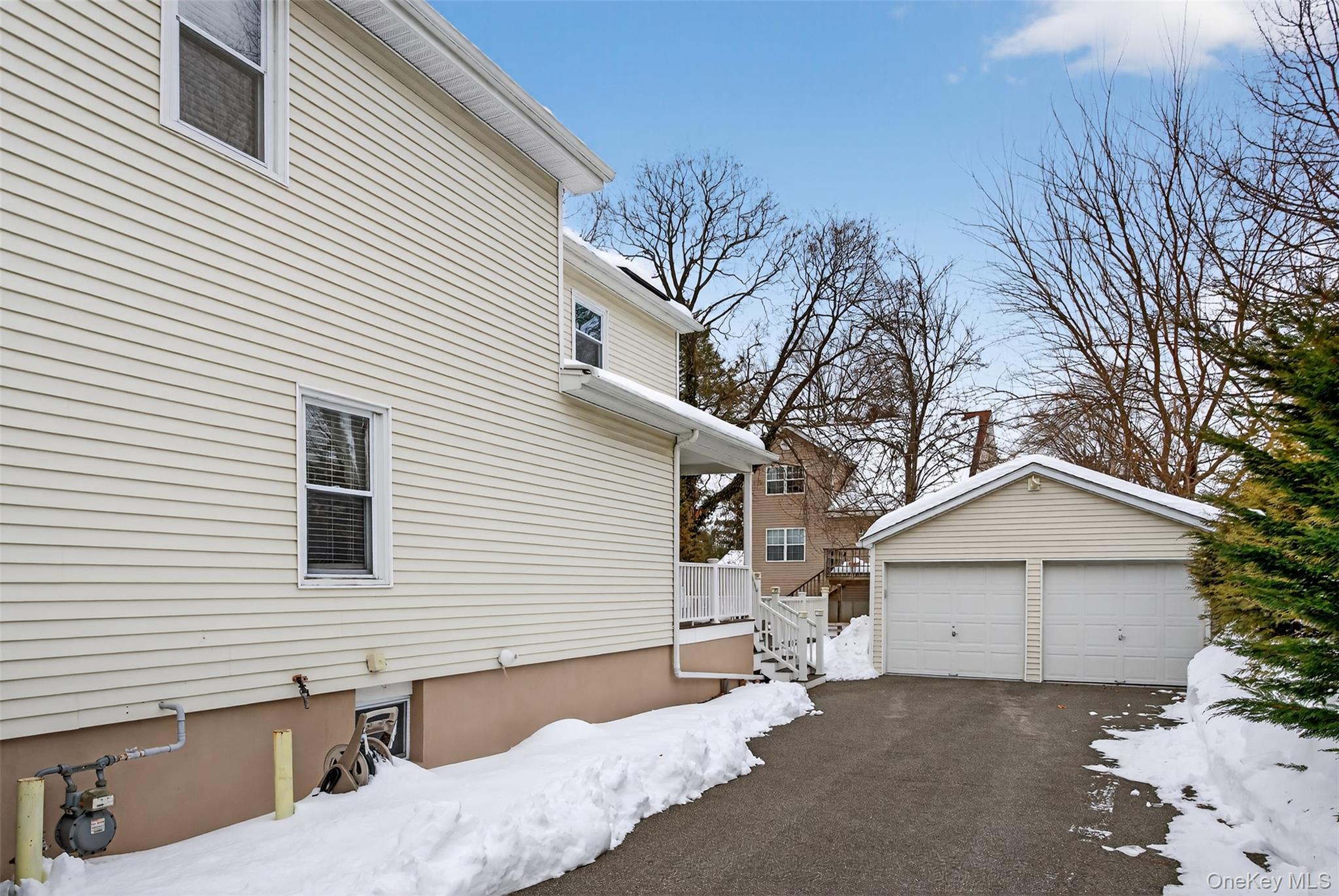 35 Kent Street Beacon, NY 12508 - Photo 35 of 40 The property features a two-car driveway with an EV charging station, as well as a two-car garage equipped with dual electric garage door openers, remote controls, and a keypad for added convenience.