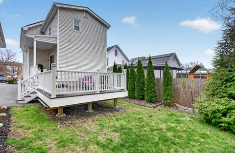 a view of a house with a yard and deck