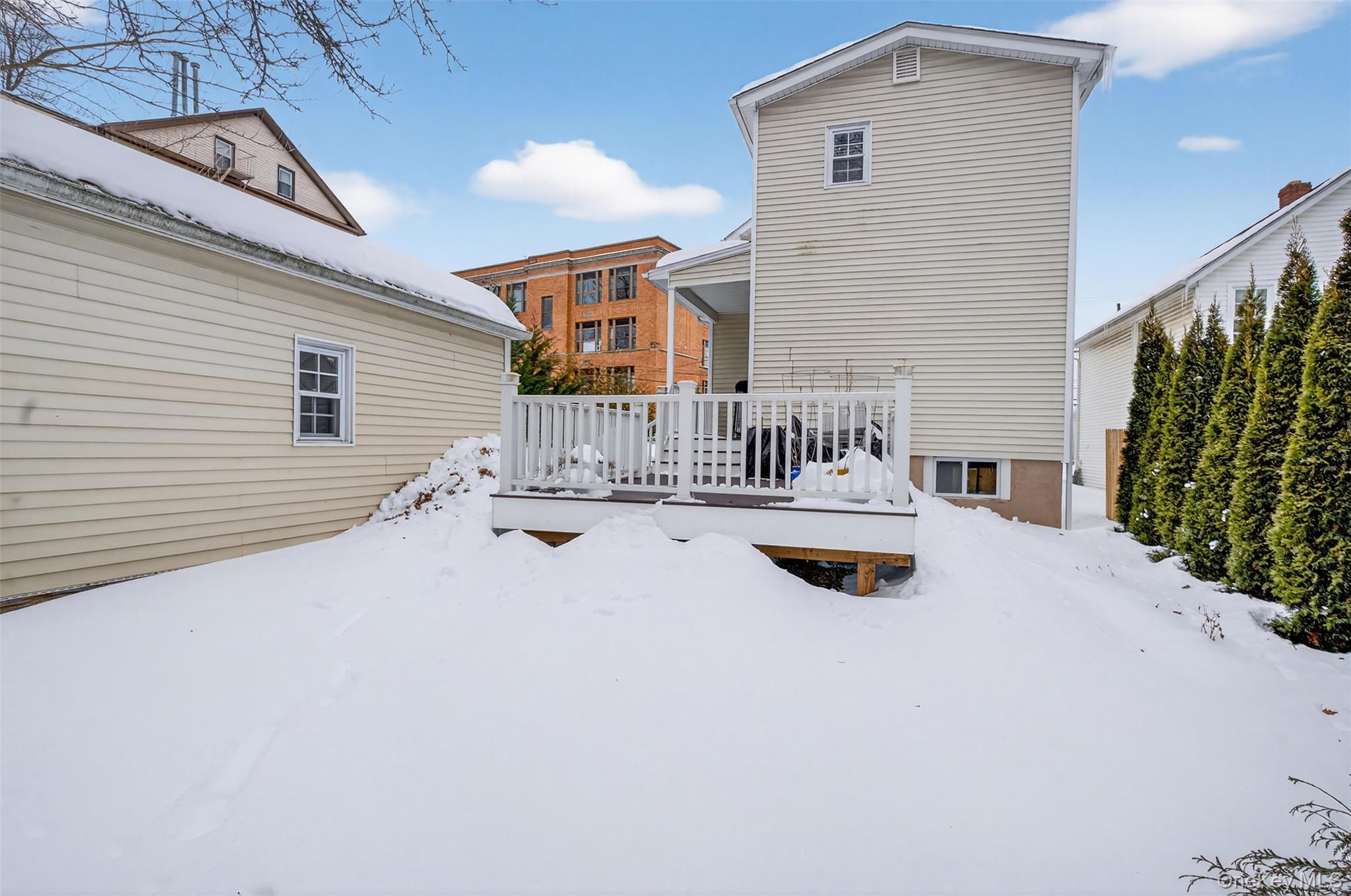 35 Kent Street Beacon, NY 12508 - Photo 36 of 40 The back of the house showcases a bi-level Trex deck and a fenced backyard, perfect for privacy and outdoor enjoyment.