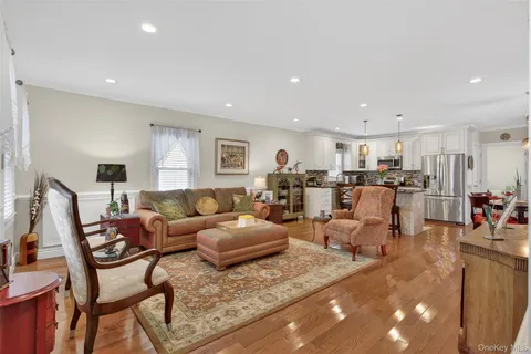 a living room with furniture kitchen view and a dining table