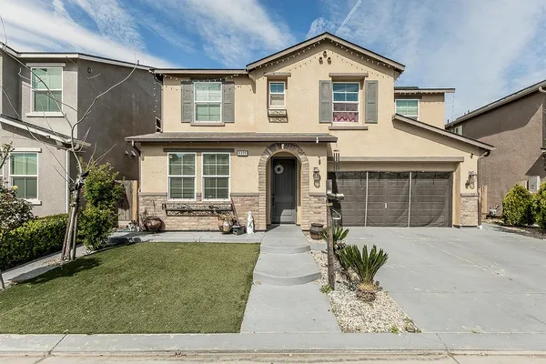 a front view of a house with a yard outdoor seating and barbeque oven