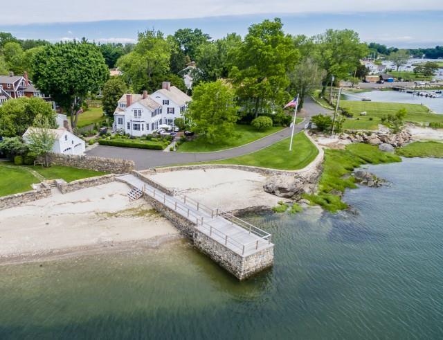 an aerial view of a house with a garden and lake view