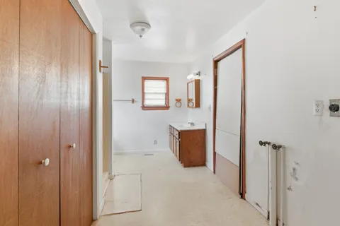 a view of a bathroom with sink mirror and window