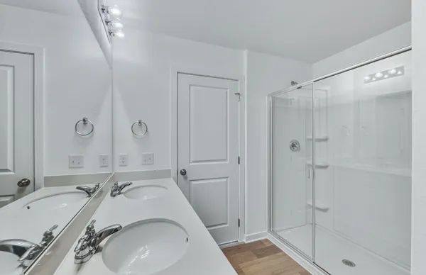 a bathroom with a sink and mirror with bathtub
