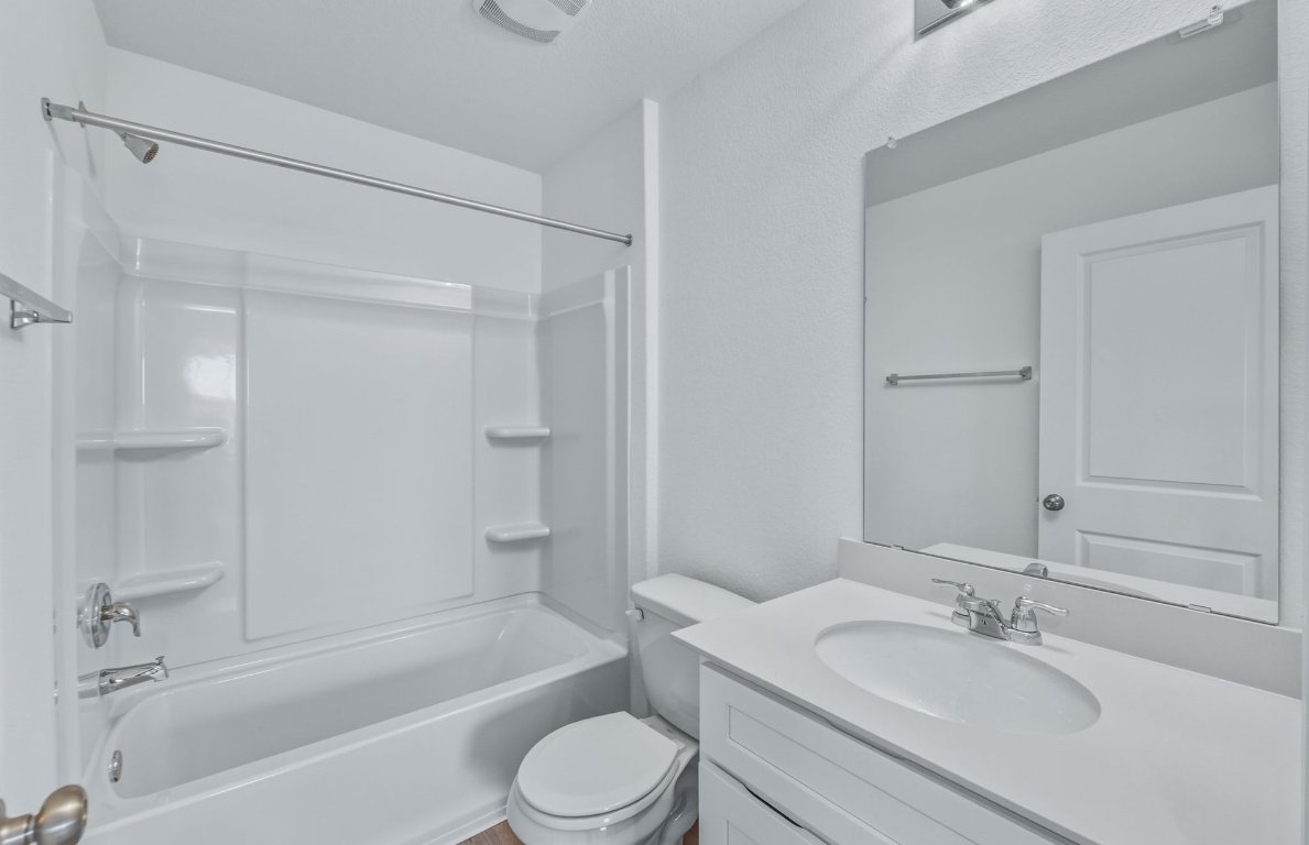 337 Sullivan Way Elgin, TX 78621 - Photo 17 of 25 a bathroom with a bathtub shower sink vanity and toilet