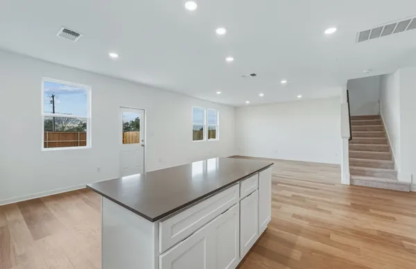 a kitchen with a sink and chandelier