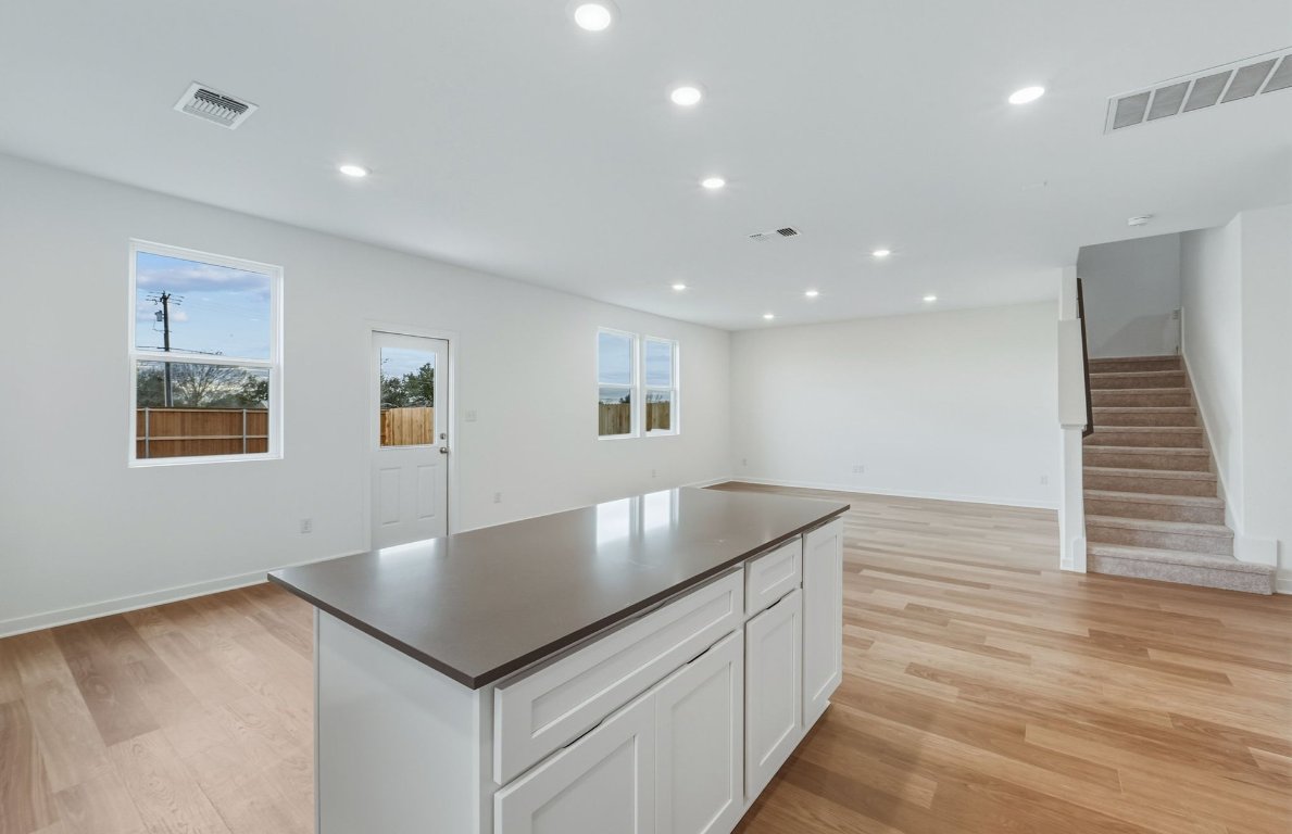 337 Sullivan Way Elgin, TX 78621 - Photo 7 of 25 a kitchen with a sink and chandelier
