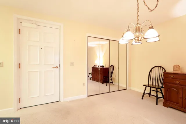 a dining room with furniture and a chandelier