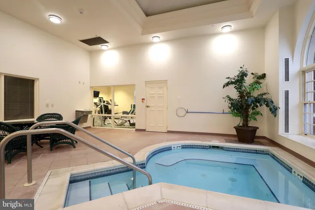 a view of a dining room with furniture a chandelier and wooden floor