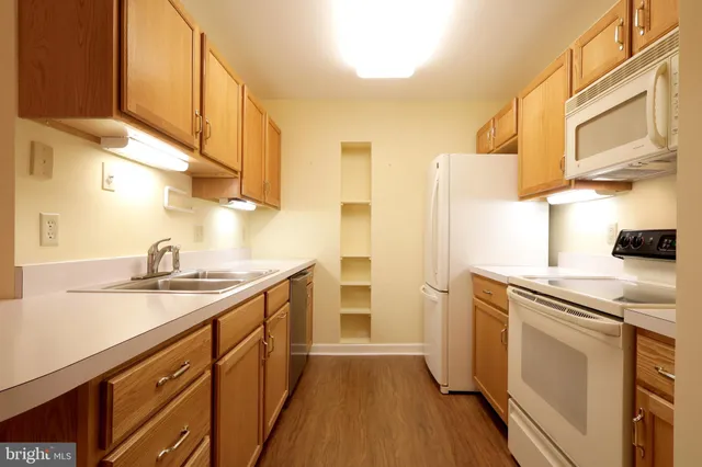a kitchen with a sink stove and refrigerator