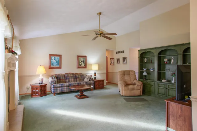 a living room with furniture gym equipment and a chandelier