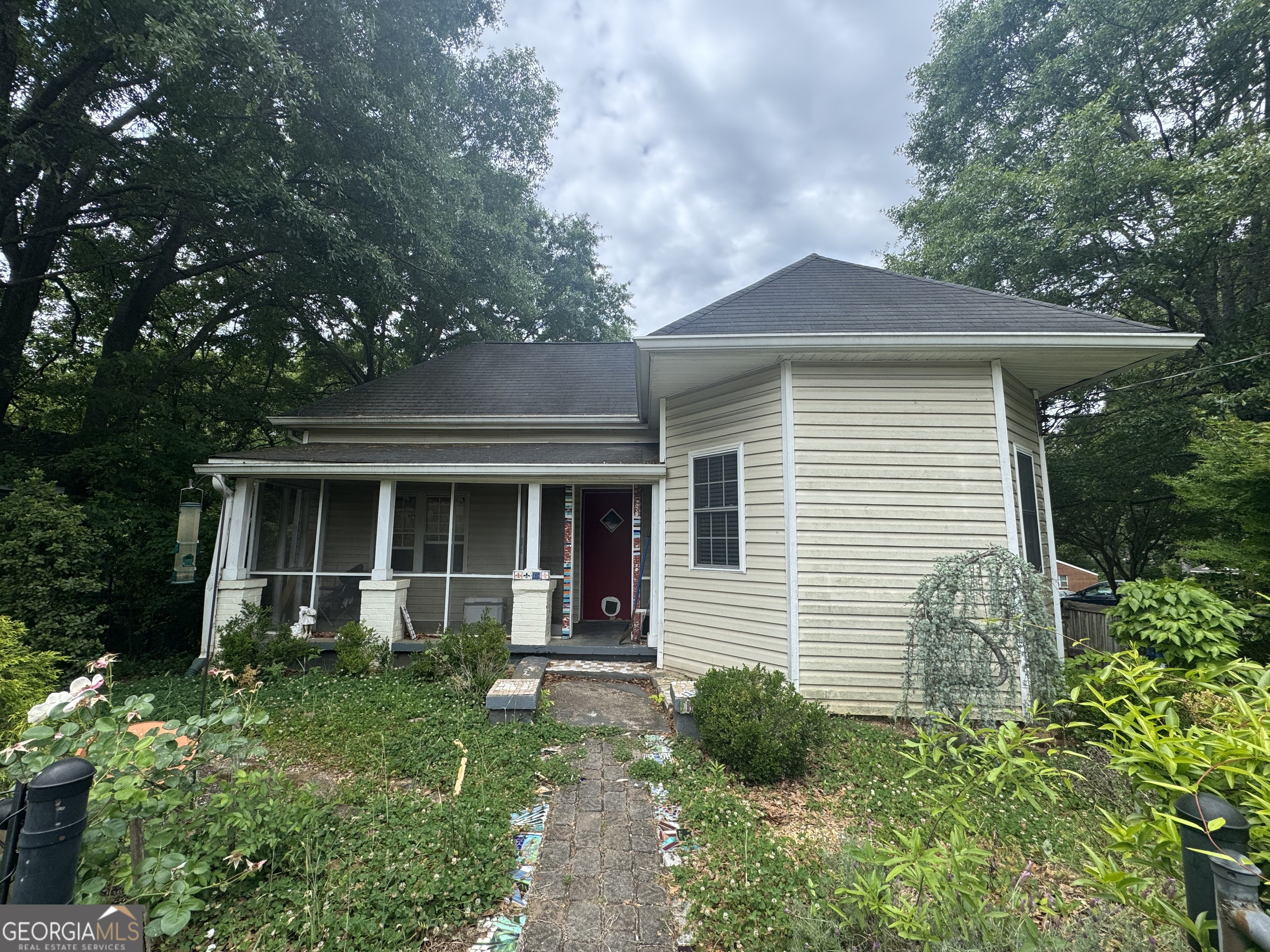 1734 East Broad Street, Unit A Athens, GA 30601 - Photo 1 of 20 a front view of a house with a yard and potted plants