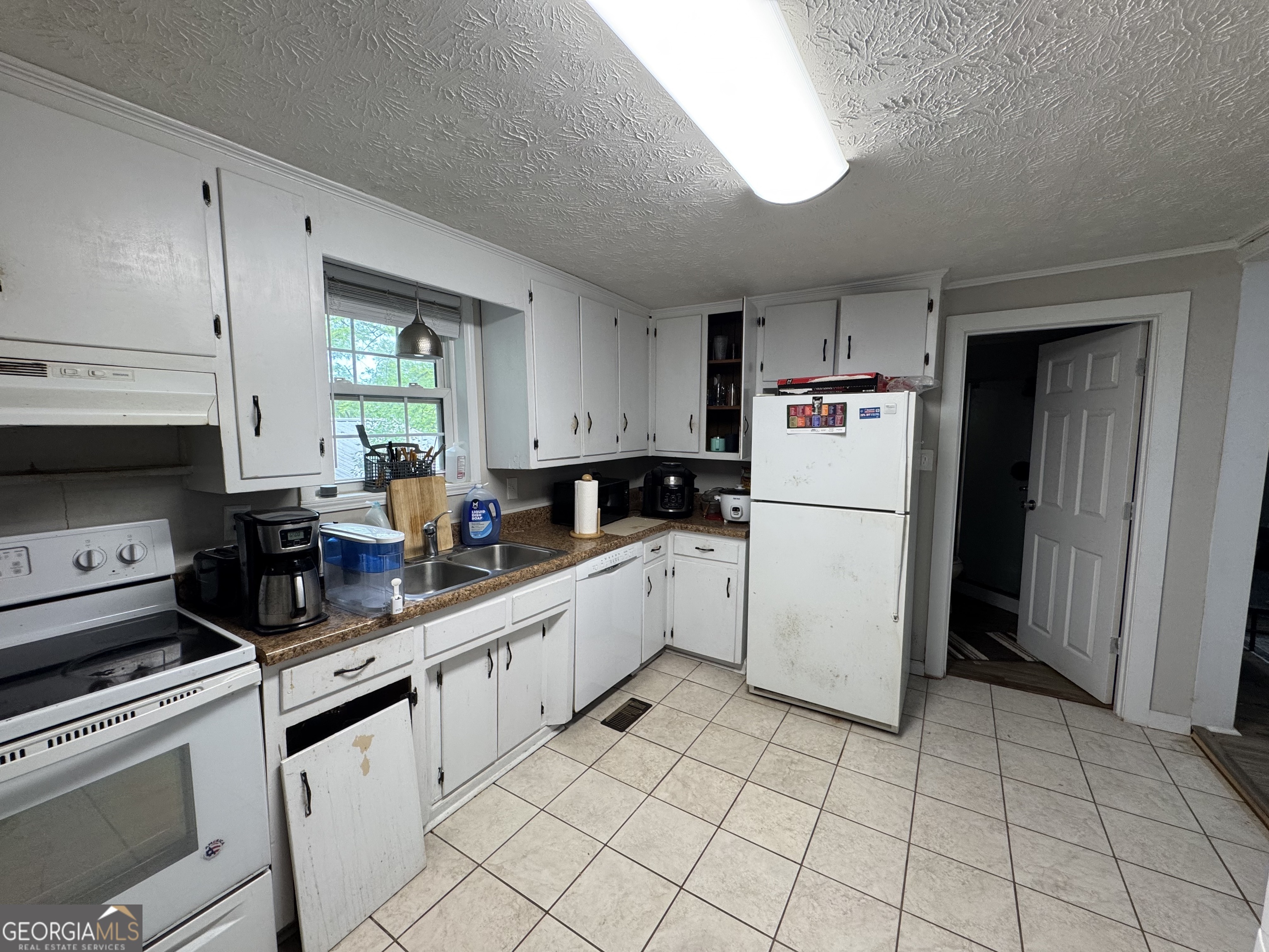 1734 East Broad Street, Unit A Athens, GA 30601 - Photo 11 of 20 a kitchen with cabinets and white appliances