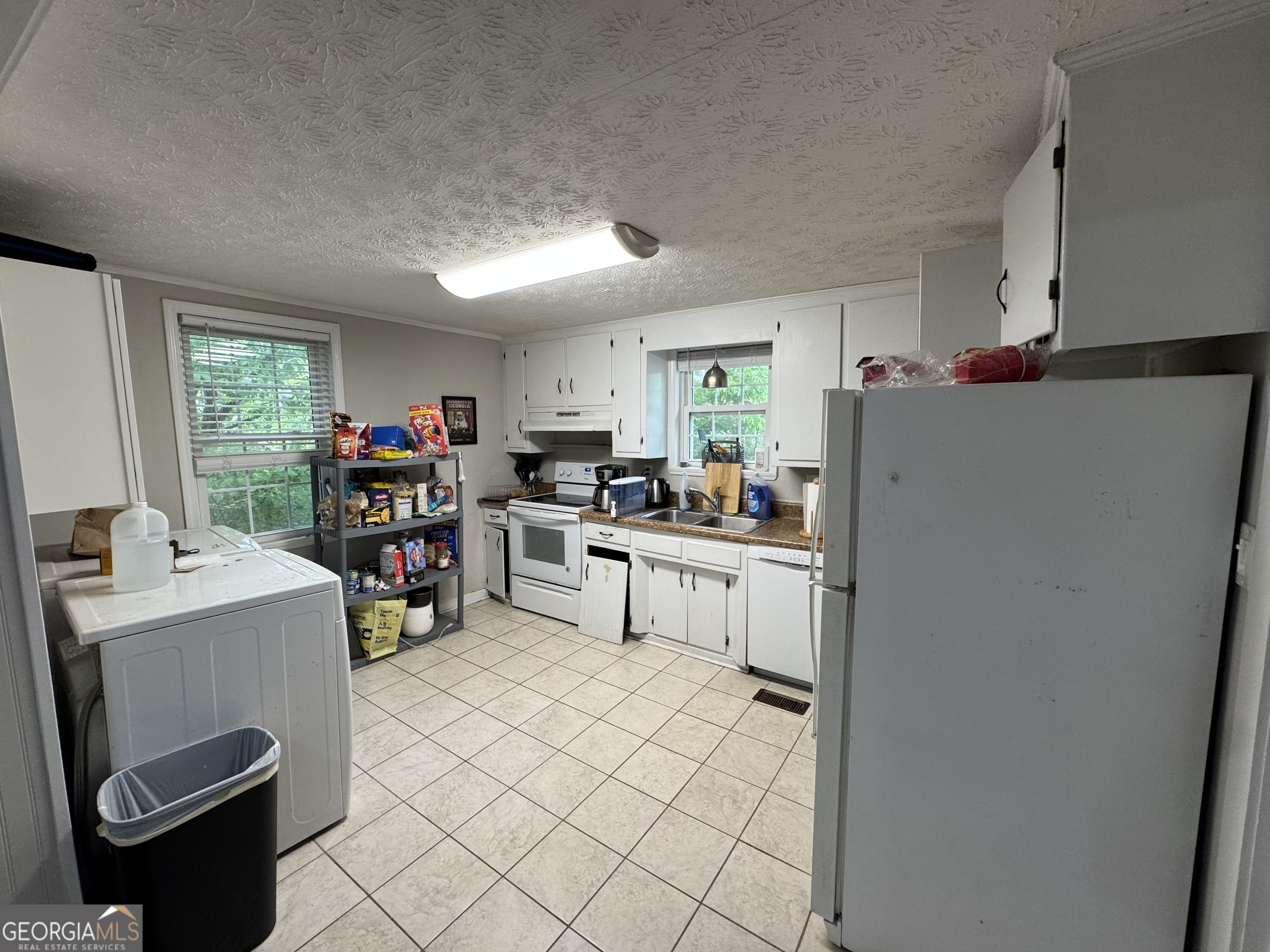 1734 East Broad Street, Unit A Athens, GA 30601 - Photo 10 of 20 a room with furniture a washer and dryer