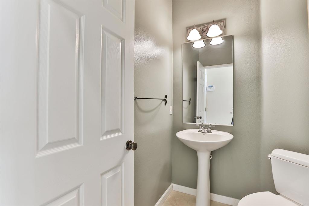 11477 Miro Circle San Diego, CA 92131 - Photo 12 of 36 a bathroom with a sink toilet and a mirror