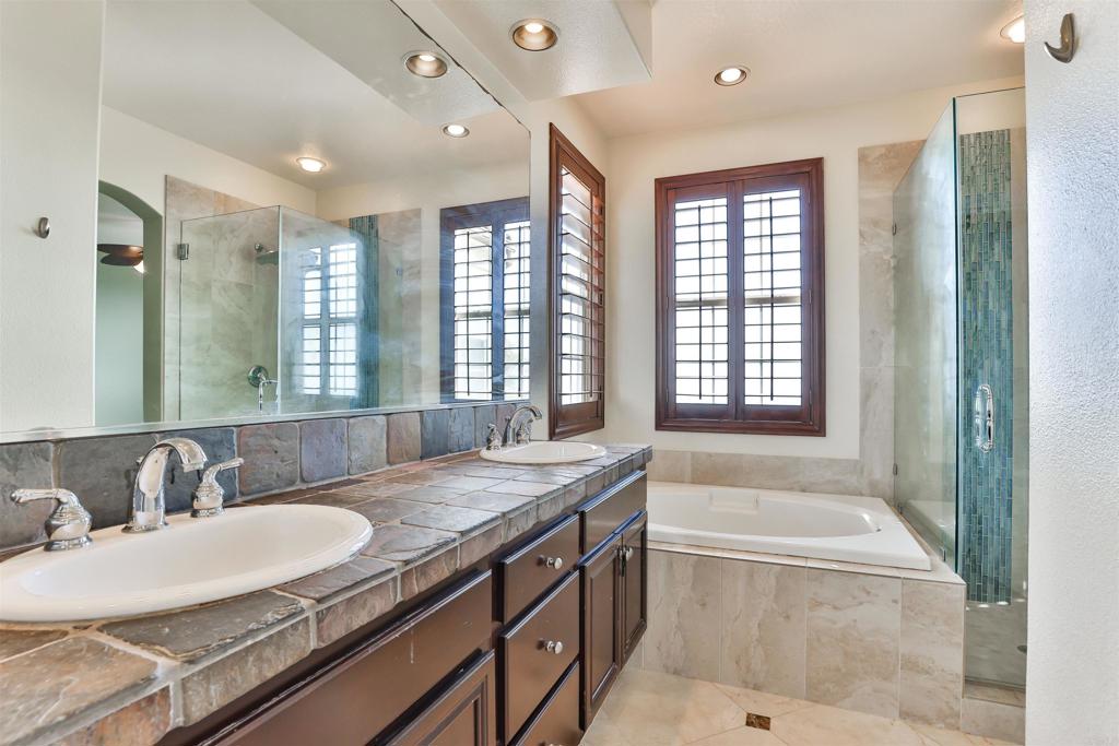 11477 Miro Circle San Diego, CA 92131 - Photo 21 of 36 a bathroom with a granite countertop sink and a large mirror