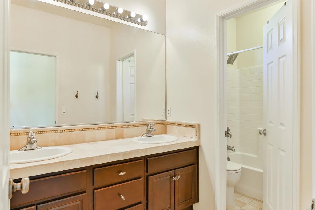 11477 Miro Circle San Diego, CA 92131 - Photo 23 of 36 a bathroom with a sink and a mirror