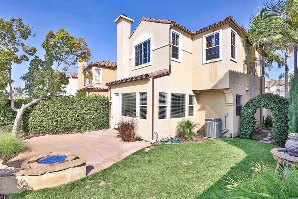 11477 Miro Circle San Diego, CA 92131 - Photo 25 of 36 a view of a white house next to a yard