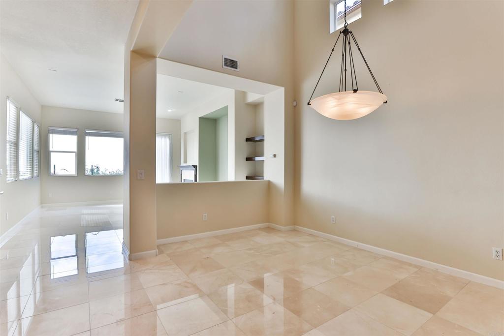 11477 Miro Circle San Diego, CA 92131 - Photo 4 of 36 a view of a hallway with a chandelier