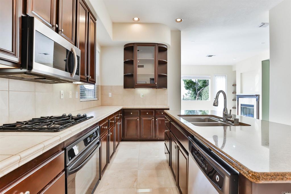 11477 Miro Circle San Diego, CA 92131 - Photo 6 of 36 a kitchen with stainless steel appliances granite countertop a sink and stove