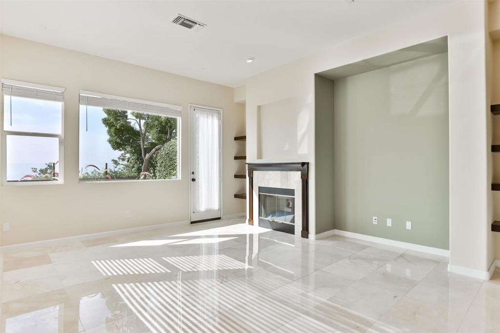 11477 Miro Circle San Diego, CA 92131 - Photo 9 of 36 a view of a livingroom with wooden floor and a large window