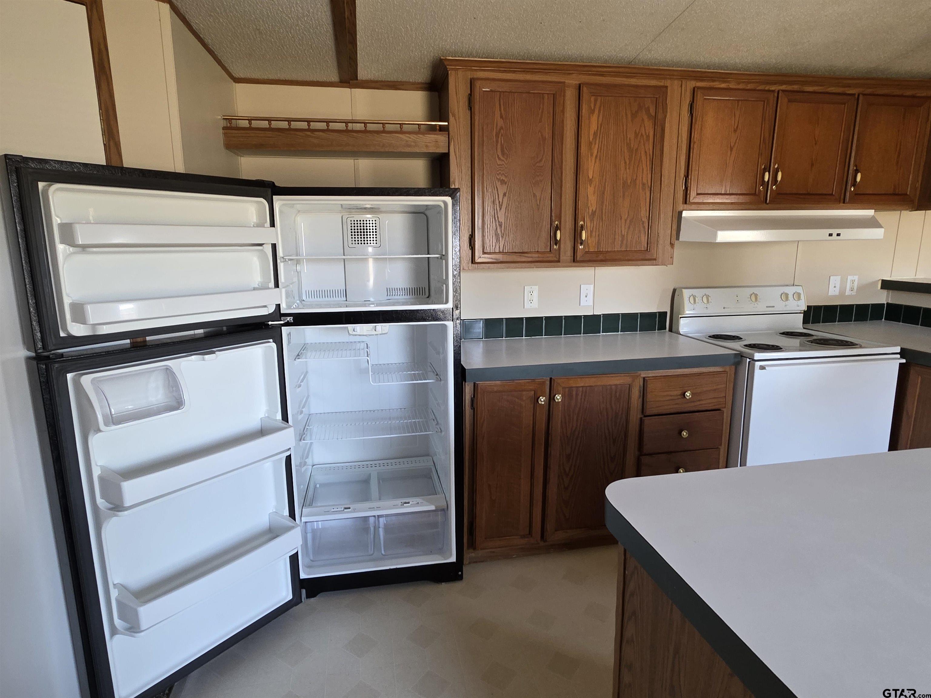 281 Sioux Quitman, TX 75783 - Photo 11 of 33 a kitchen with cabinets and stainless steel appliances