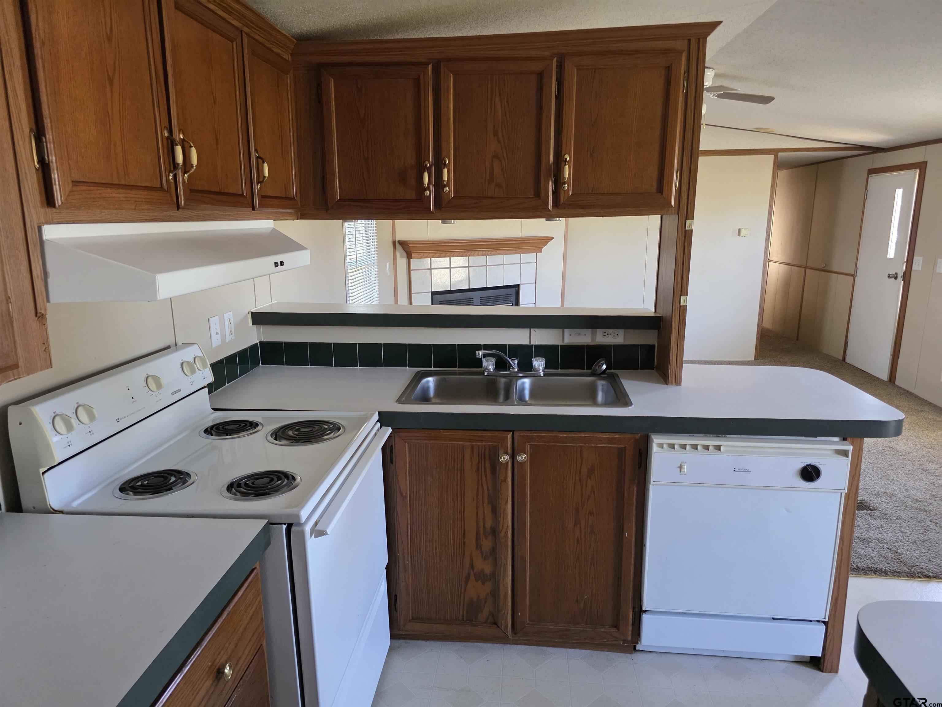 281 Sioux Quitman, TX 75783 - Photo 12 of 33 a kitchen with a sink a stove and cabinets