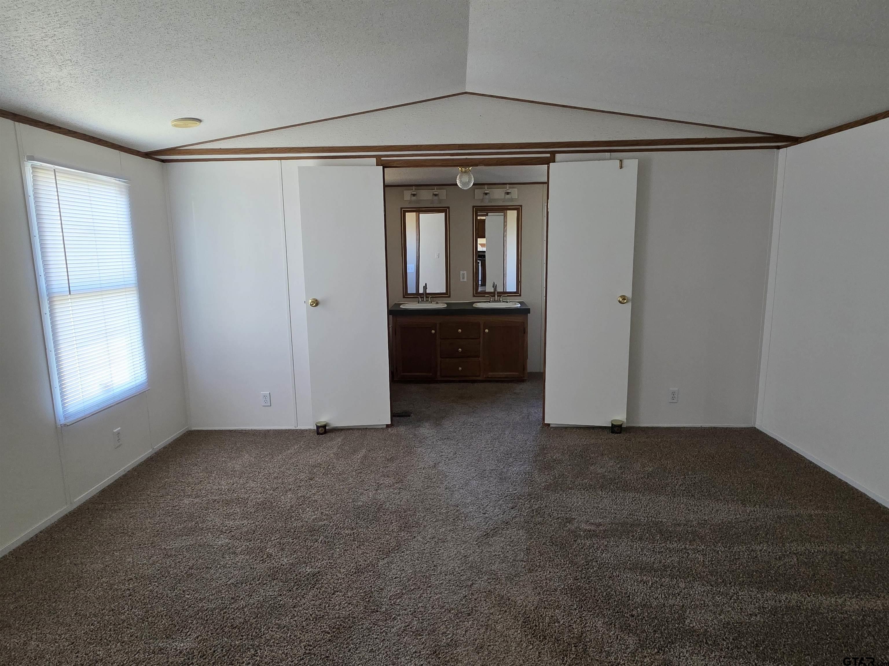 281 Sioux Quitman, TX 75783 - Photo 15 of 33 a view of a big room with windows and chandelier fan
