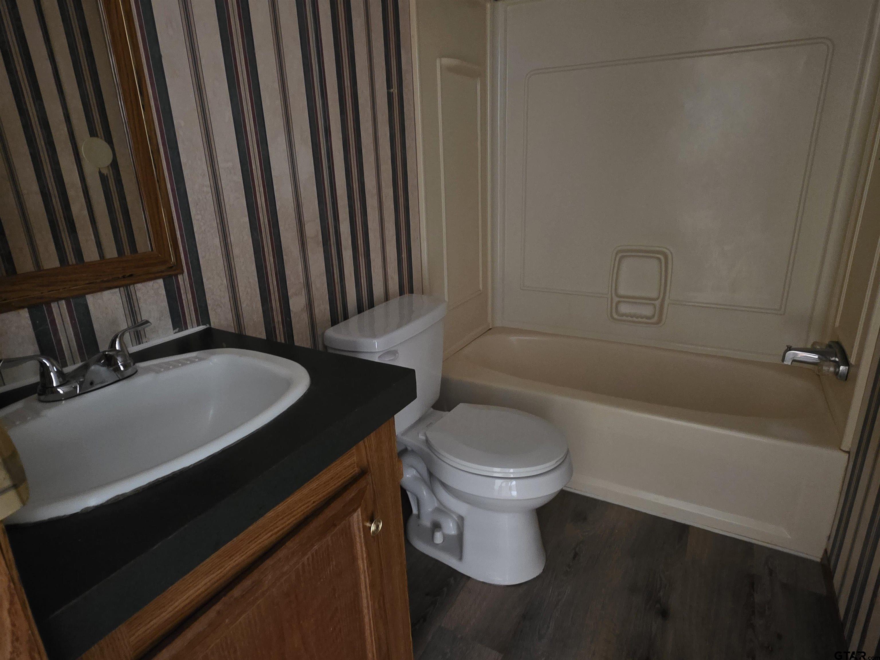 281 Sioux Quitman, TX 75783 - Photo 21 of 33 a bathroom with a sink a toilet and bathtub
