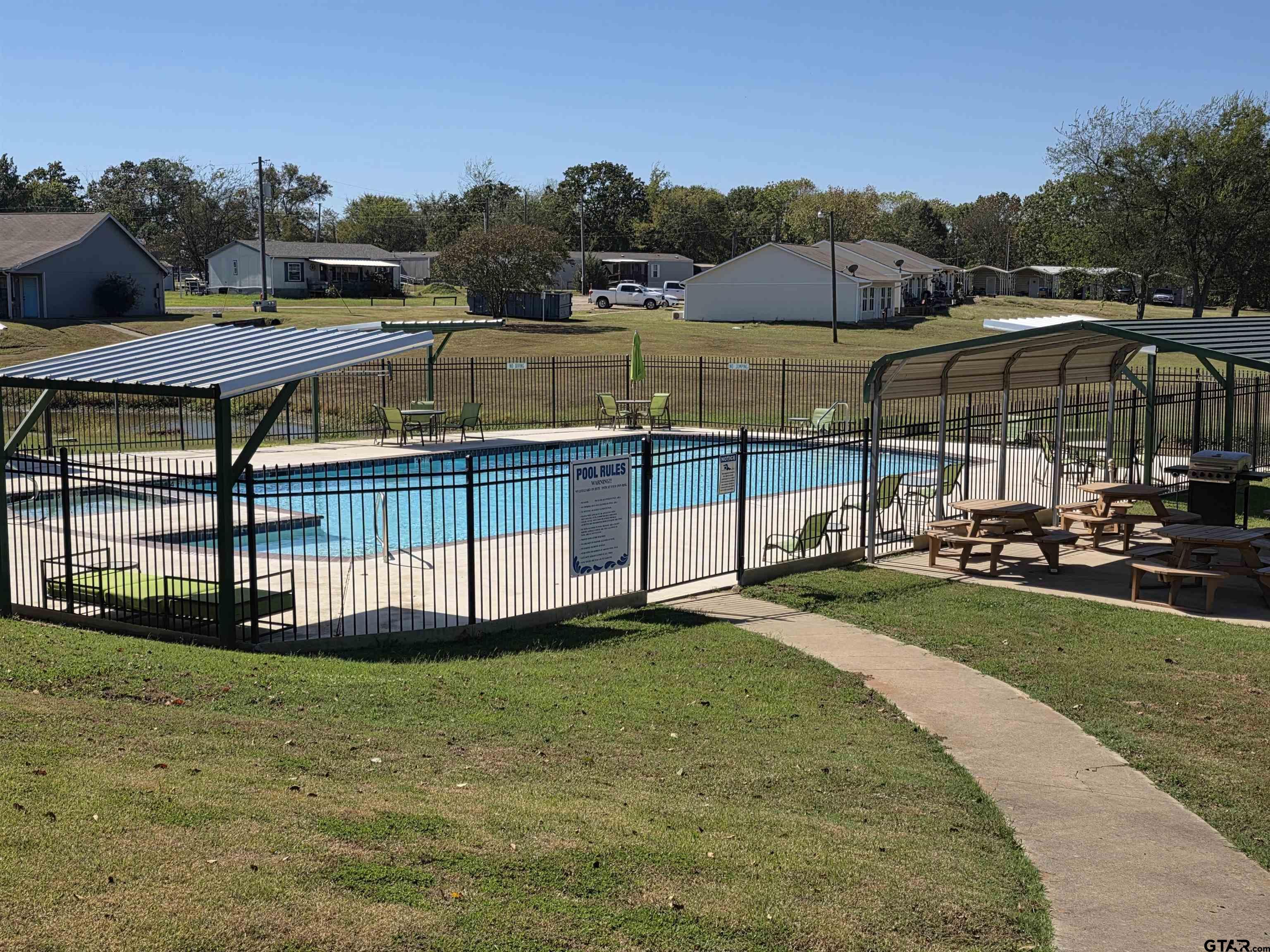 281 Sioux Quitman, TX 75783 - Photo 27 of 33 a view of a swimming pool with a garden