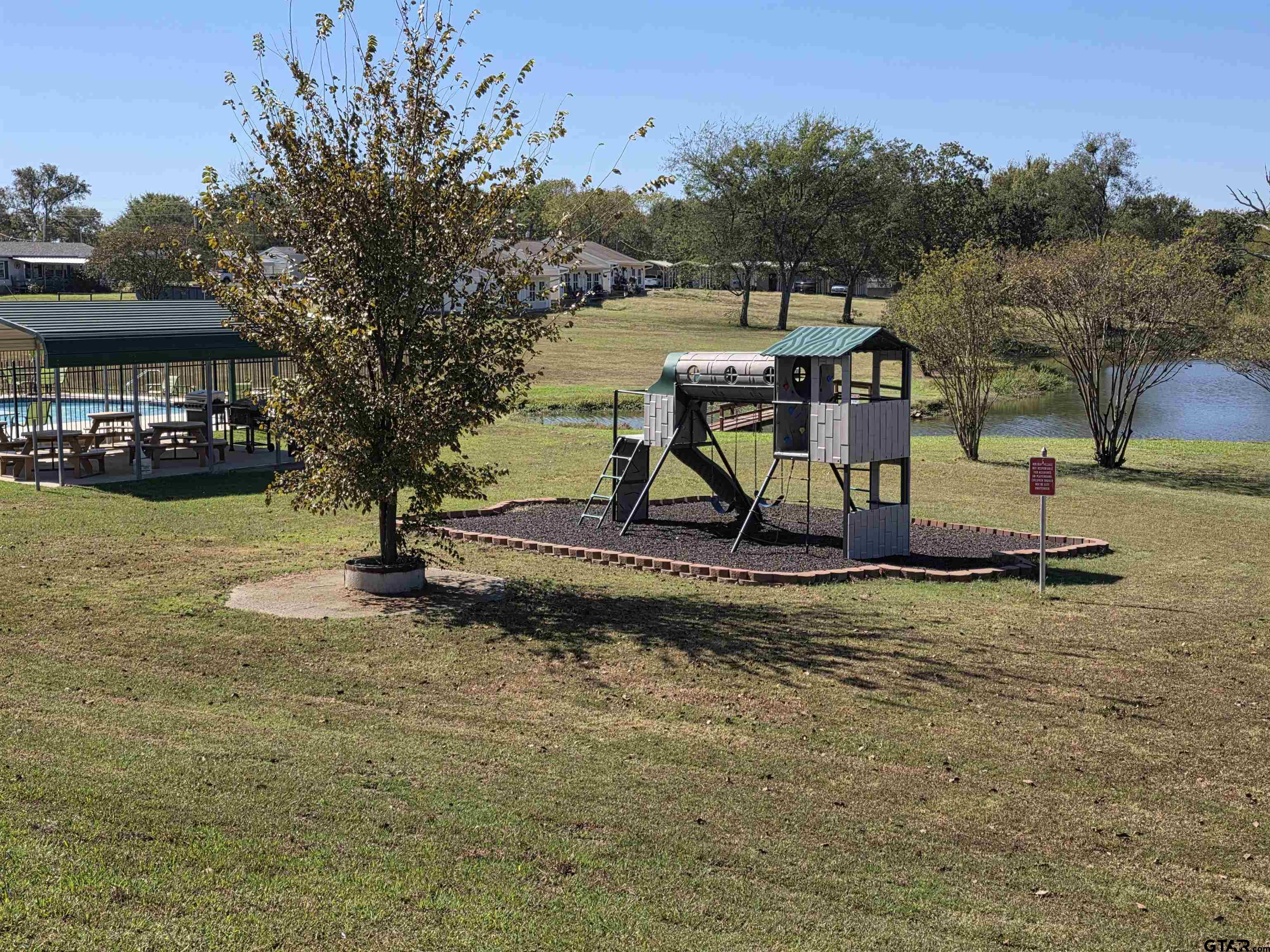 281 Sioux Quitman, TX 75783 - Photo 32 of 33 a view of a lake with a yard and a large tree