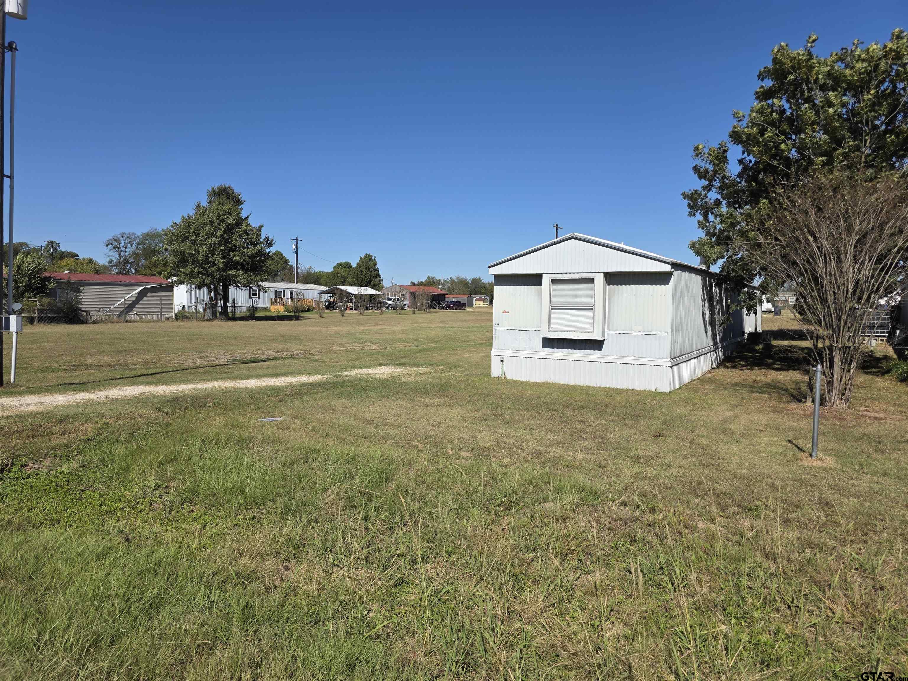 281 Sioux Quitman, TX 75783 - Photo 4 of 33 a front view of a house with a yard