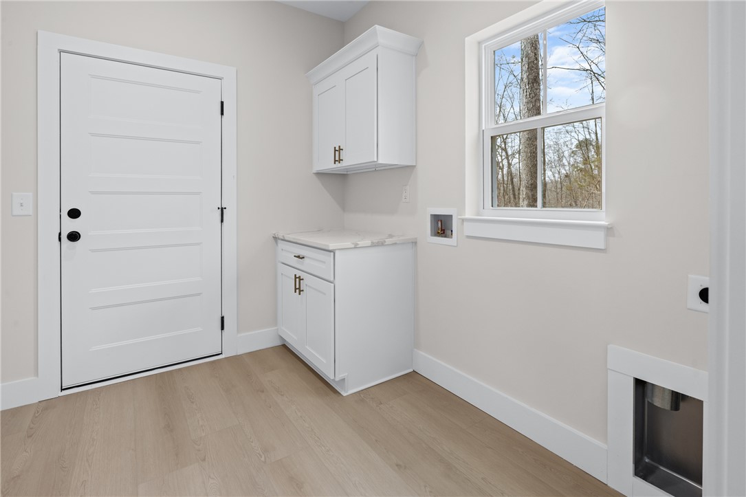 322 Oconee Avenue Westminster, SC 29693 - Photo 18 of 43 This bright laundry room features ample storage and natural light.