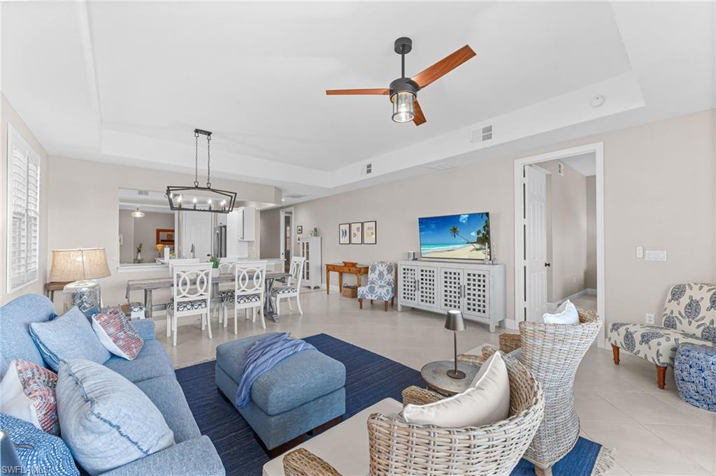 6418 Legacy Circle, Unit 802 Naples, FL 34113 - Photo 9 of 47 a living room with furniture and wooden floor