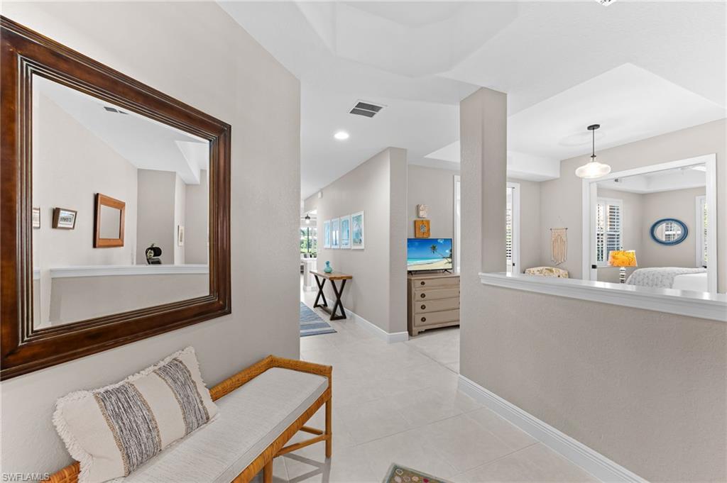 6418 Legacy Circle, Unit 802 Naples, FL 34113 - Photo 12 of 47 a living room with furniture and a kitchen